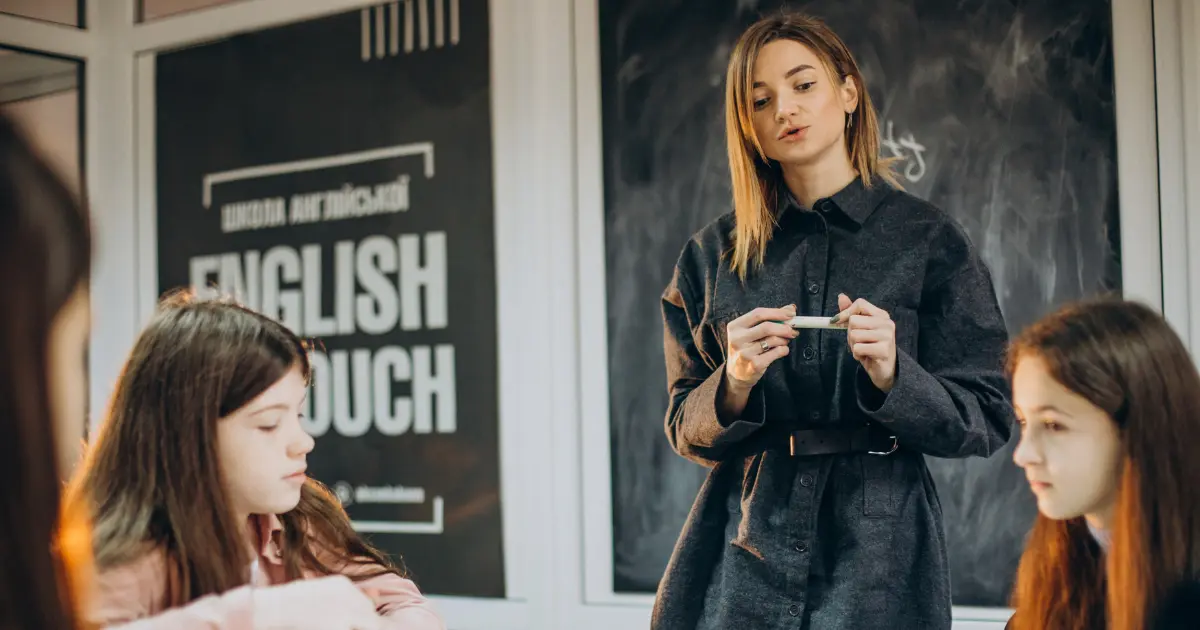 A woman instructs her students in an English speaking course